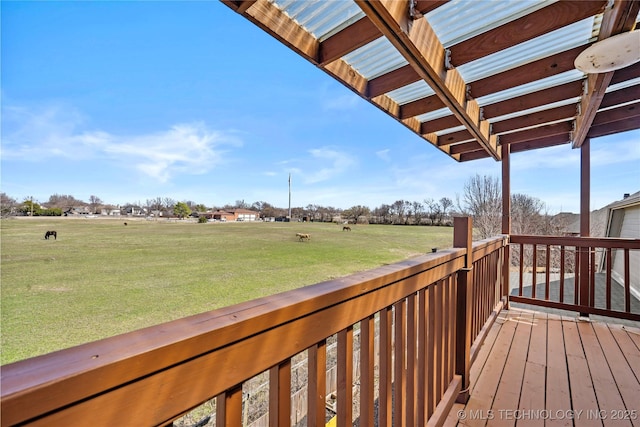 wooden deck featuring a lawn