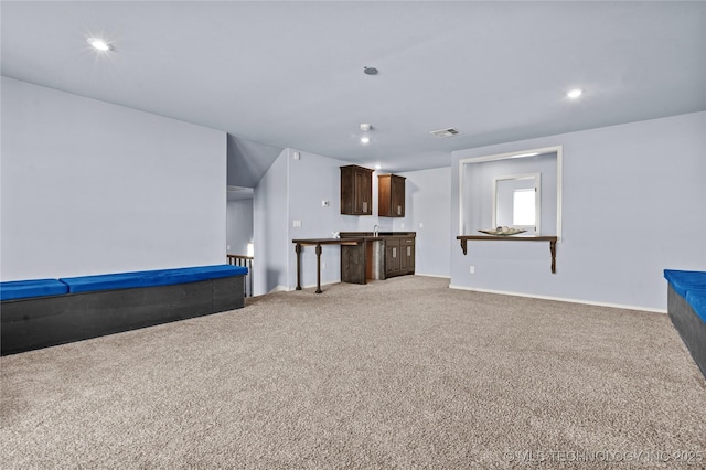 unfurnished living room featuring baseboards, recessed lighting, visible vents, and light carpet