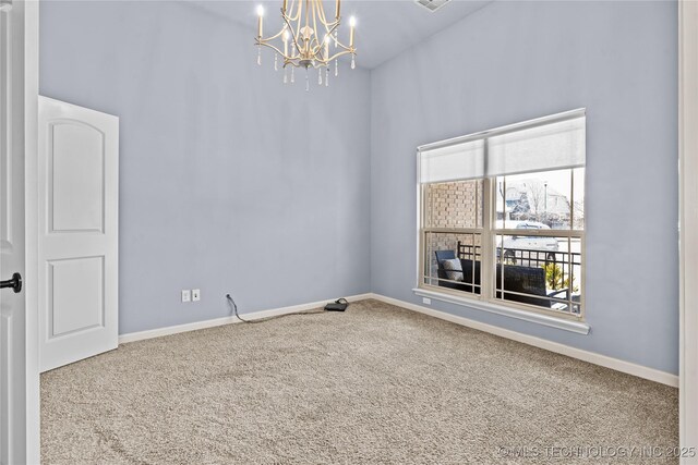 carpeted spare room featuring visible vents, baseboards, and an inviting chandelier