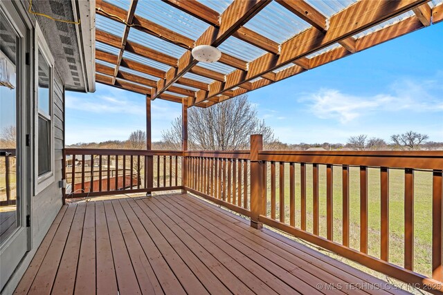 wooden terrace featuring a lawn and a pergola