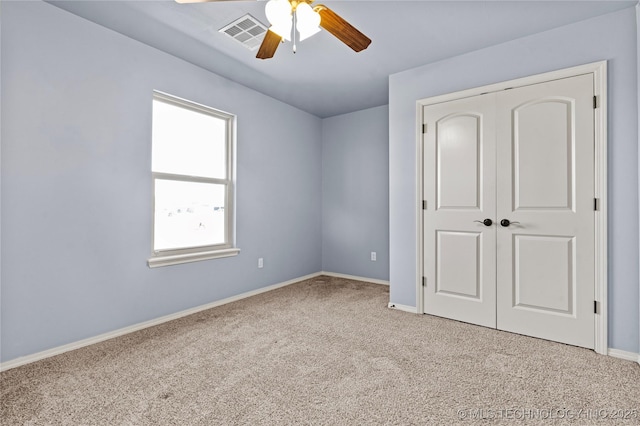 unfurnished bedroom with visible vents, baseboards, light colored carpet, and a closet