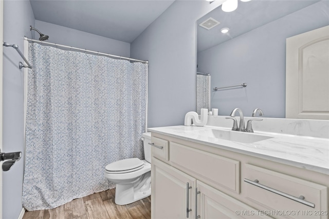 full bath featuring visible vents, toilet, vanity, and wood finished floors