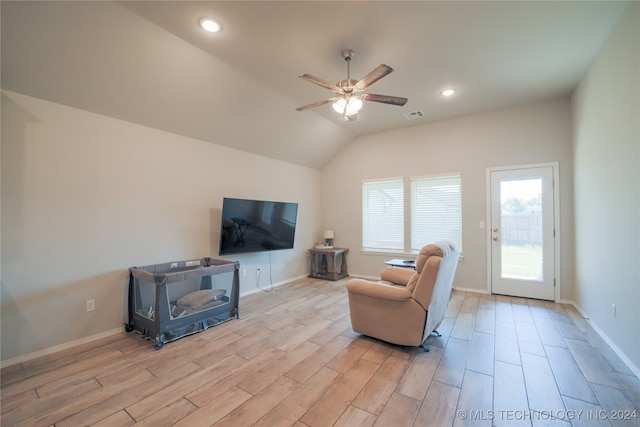 living room with ceiling fan and lofted ceiling