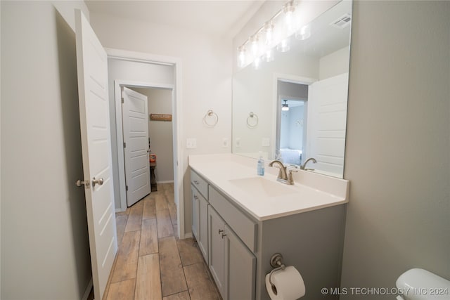 bathroom featuring toilet and vanity