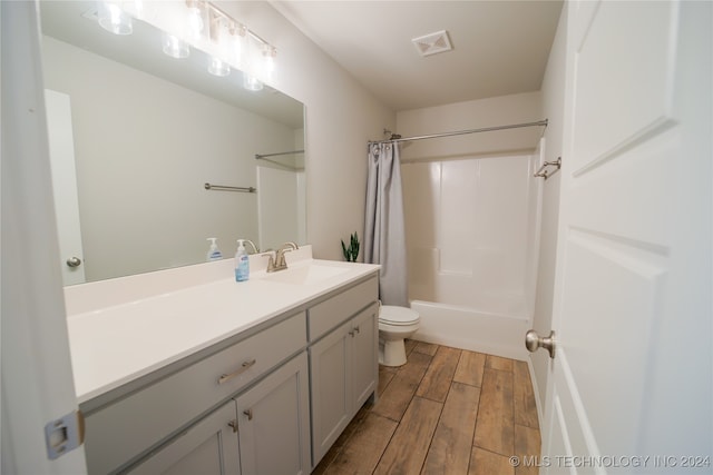 full bathroom with toilet, vanity, and shower / tub combo with curtain