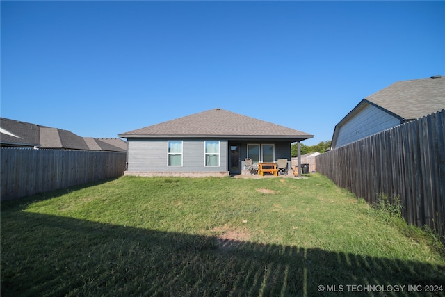 rear view of house with a yard