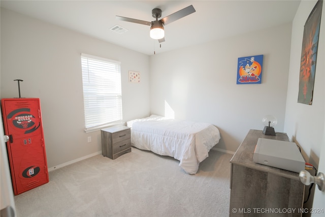 carpeted bedroom featuring ceiling fan and multiple windows