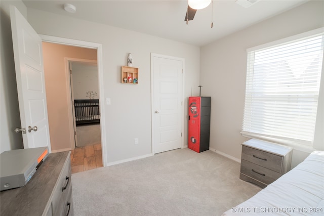 bedroom with ceiling fan and light colored carpet