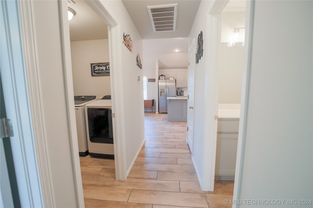 hallway with washing machine and dryer