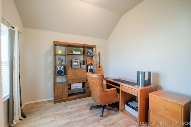 home office featuring vaulted ceiling and light hardwood / wood-style flooring