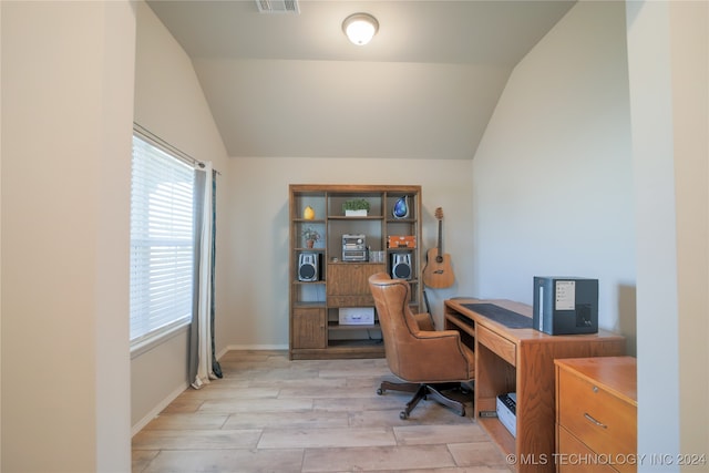 office with a healthy amount of sunlight, lofted ceiling, and light wood-type flooring