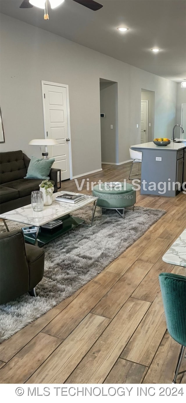 living room featuring ceiling fan and sink