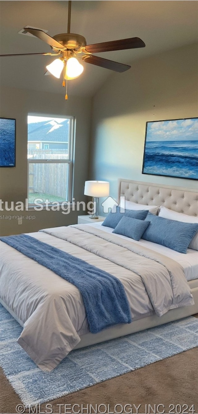 bedroom with ceiling fan, vaulted ceiling, and carpet flooring