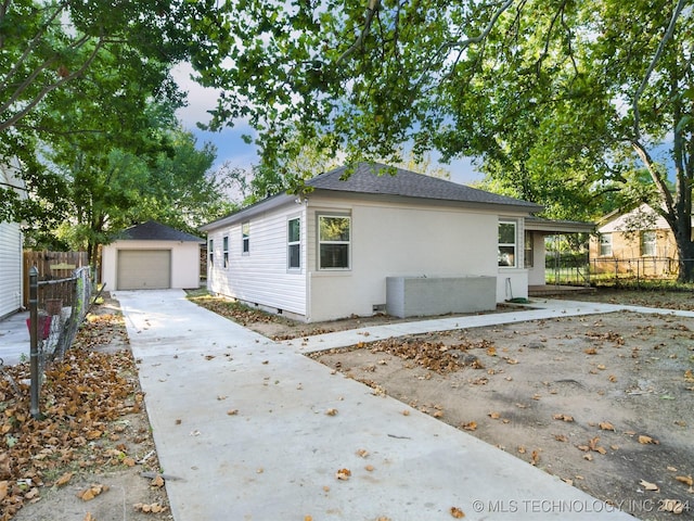 view of home's exterior with a garage and an outdoor structure