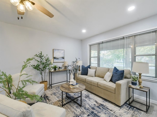 living room with hardwood / wood-style floors and ceiling fan