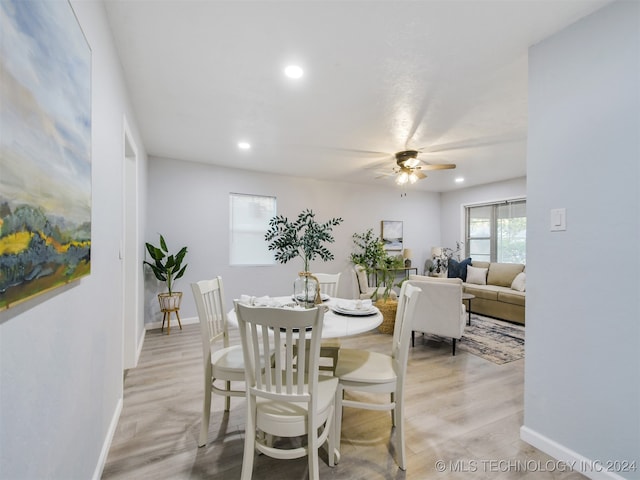 dining room with light hardwood / wood-style flooring and ceiling fan