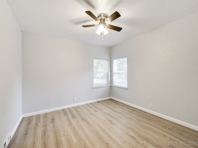 unfurnished room with ceiling fan and light hardwood / wood-style flooring