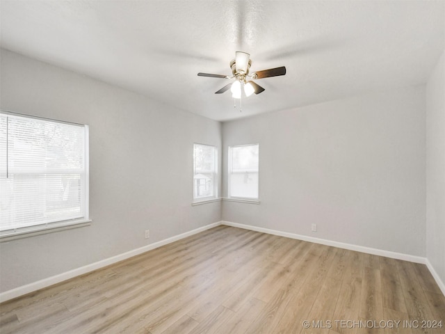 509 G St SW, Ardmore, OK 73401 - spare room featuring baseboards, a ceiling fan, and light wood finished floors