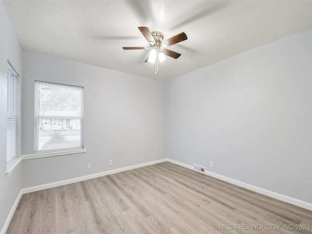 spare room with light hardwood / wood-style floors and ceiling fan