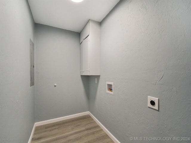 509 G St SW, Ardmore, OK 73401 - laundry area featuring cabinet space, hookup for a washing machine, electric dryer hookup, baseboards, and wood finished floors