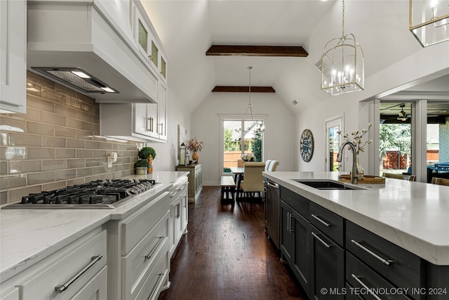 kitchen with custom exhaust hood, white cabinets, appliances with stainless steel finishes, dark hardwood / wood-style floors, and pendant lighting