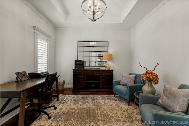 office space featuring a tray ceiling, crown molding, hardwood / wood-style flooring, and an inviting chandelier