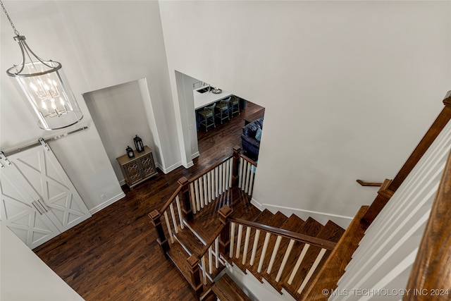 stairs featuring hardwood / wood-style floors and a barn door