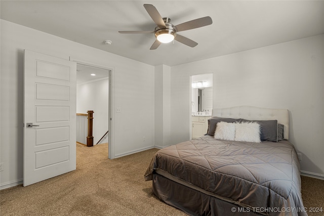 bedroom featuring light carpet, ensuite bathroom, and ceiling fan