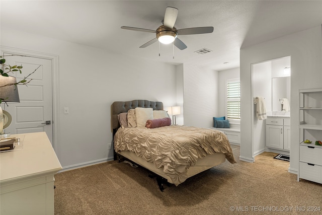 bedroom with light colored carpet, connected bathroom, and ceiling fan