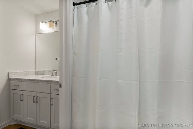 bathroom featuring vanity and curtained shower