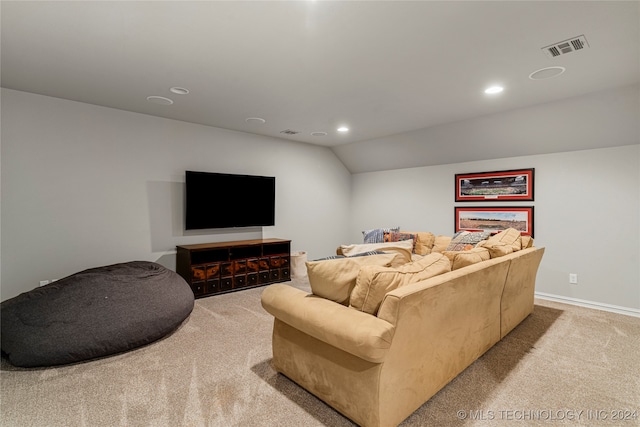 carpeted living room featuring vaulted ceiling