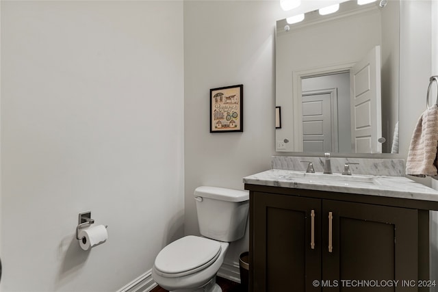 bathroom featuring toilet and vanity