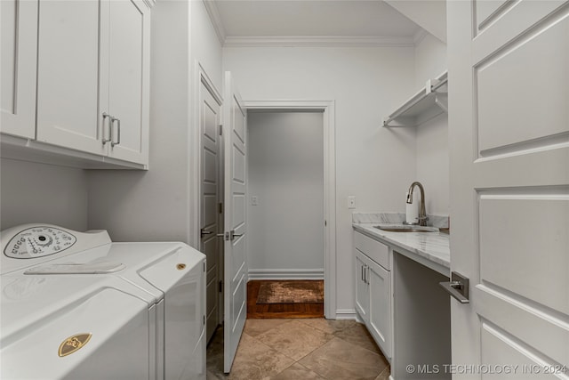 laundry room featuring crown molding, cabinets, sink, and independent washer and dryer