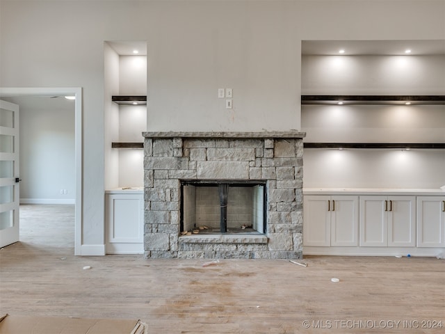 unfurnished living room featuring light hardwood / wood-style floors and a fireplace