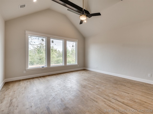 spare room with ceiling fan, lofted ceiling, and light hardwood / wood-style floors