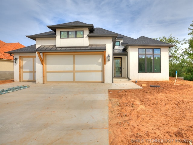 prairie-style home featuring a garage