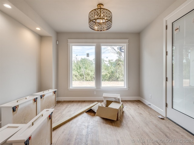 interior space with light hardwood / wood-style floors and a chandelier