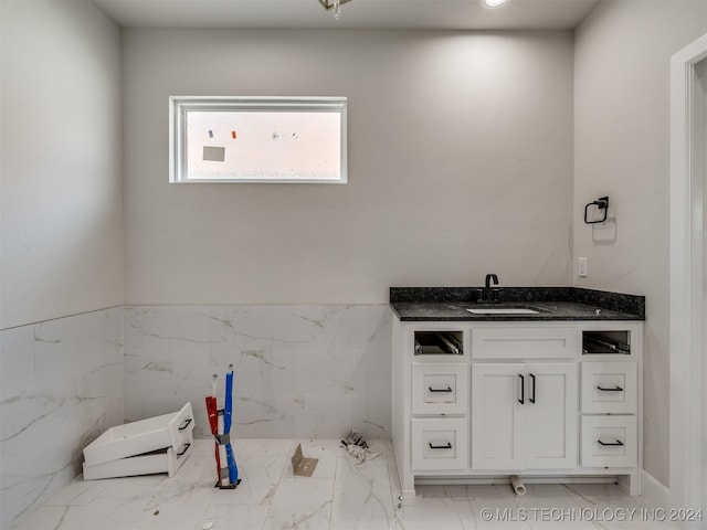 bathroom with tile walls and vanity