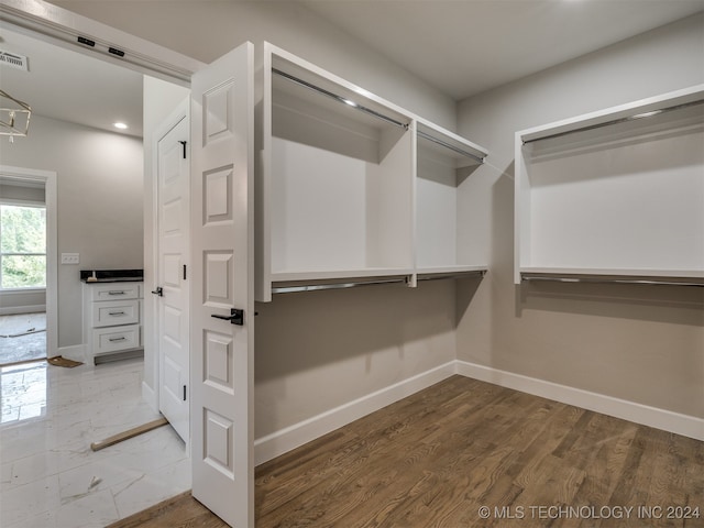 walk in closet featuring hardwood / wood-style floors