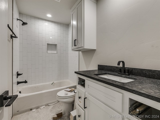 full bathroom with vanity, toilet, and tiled shower / bath