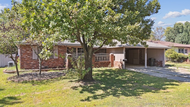 single story home with a carport, central AC unit, and a front yard