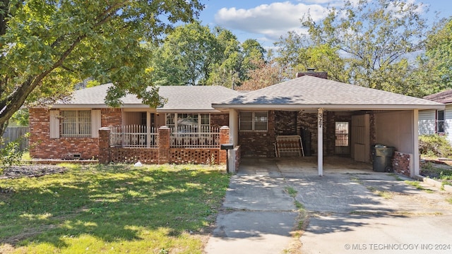 ranch-style house with a front yard and a carport