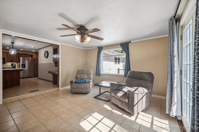 living area featuring ceiling fan, light tile patterned floors, and ornamental molding