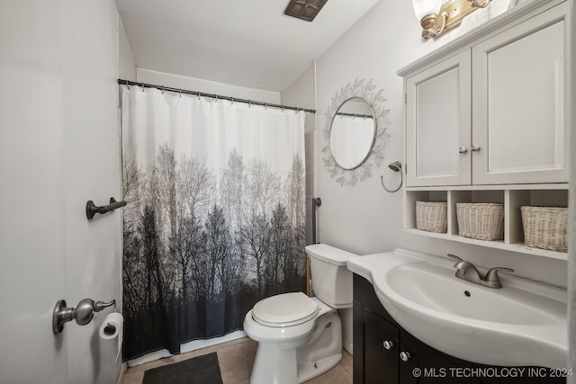 bathroom featuring a shower with shower curtain, vanity, tile patterned floors, and toilet