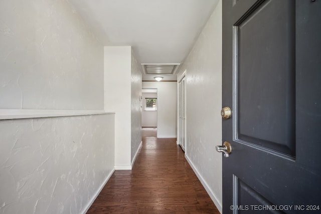 corridor with dark hardwood / wood-style flooring