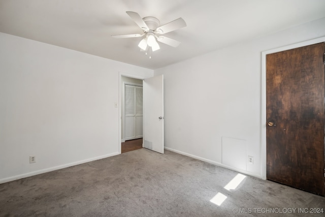 unfurnished bedroom with carpet floors, a closet, and ceiling fan