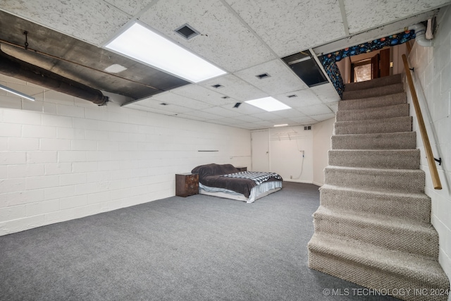 basement with carpet flooring and a drop ceiling