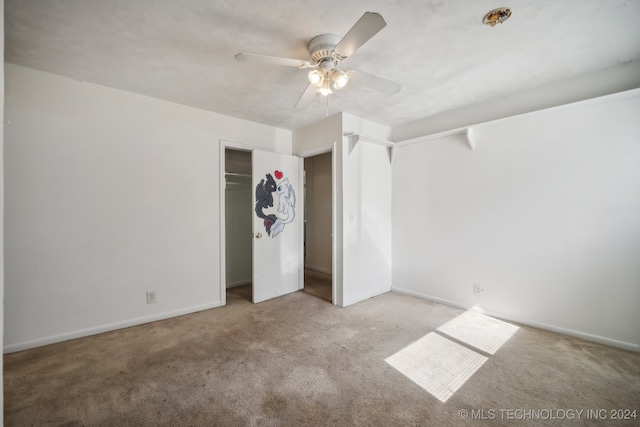 unfurnished bedroom featuring ceiling fan, a closet, and light carpet