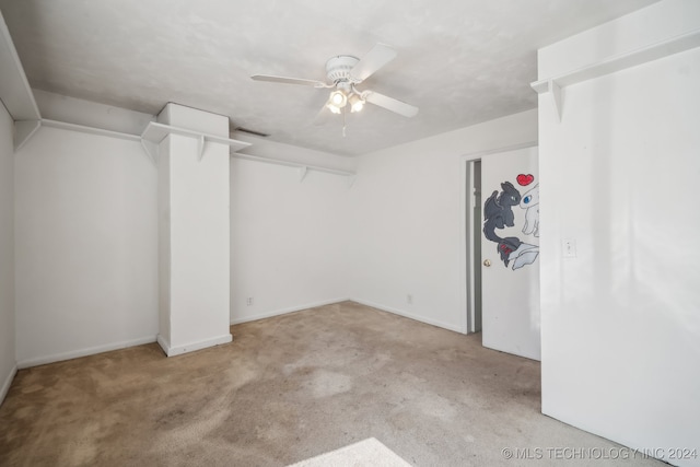 interior space with light carpet and ceiling fan