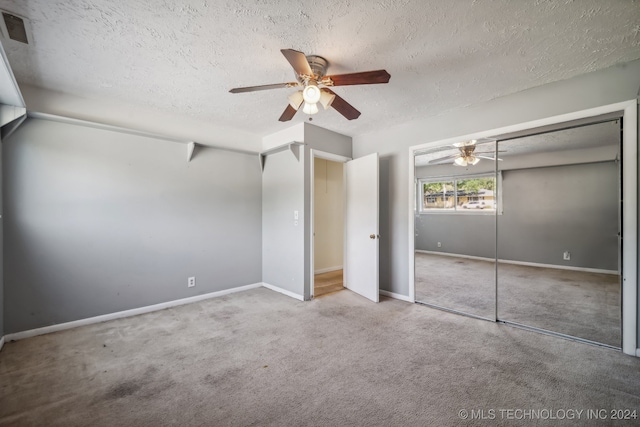 unfurnished bedroom featuring a textured ceiling, carpet flooring, ceiling fan, and a closet